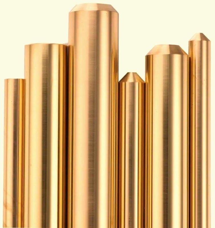 brass rods of varying heights and widths against a white background.